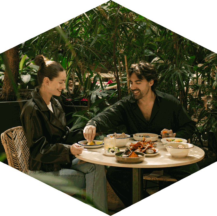 Guests sharing dishes in the Twentysix garden